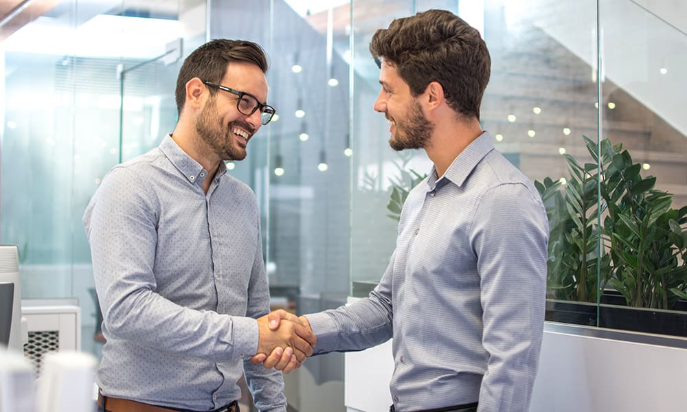What People Say About Us - Two Business People Shaking Hands